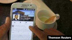 FILE - A person uses a smartphone to look at the Facebook page of Cambodia's Prime Minister Hun Sen at a restaurant in central Phnom Penh, Cambodia, Oct. 7, 2015.