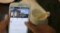 FILE - A person uses a smartphone to look at the Facebook page of Cambodia's Prime Minister Hun Sen at a restaurant in central Phnom Penh, Cambodia, Oct. 7, 2015.