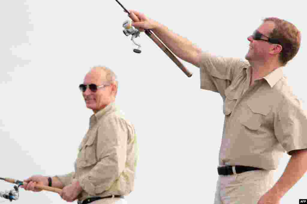 Dmitry Medvedev and Prime Minister Putin enjoy some fishing on the river Volga in Russia's Astrakhan region August 16, 2011. (Reuters)