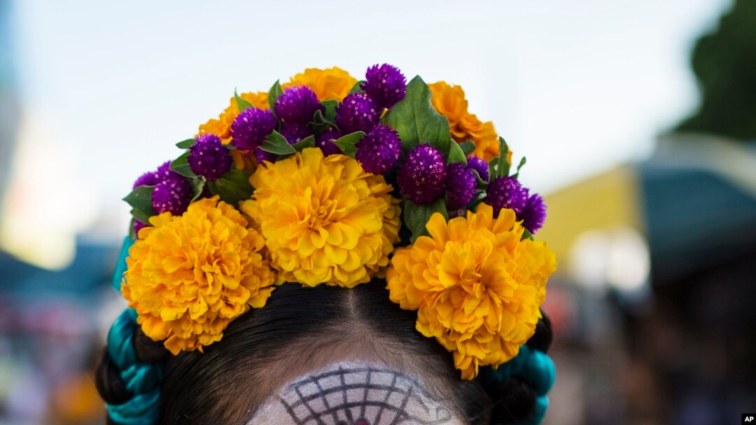 Marla Fernandez, 12, poses for a picture before the start of a Day of the Dead parade in Juchitan, Mexico, Oct. 31, 2018. 