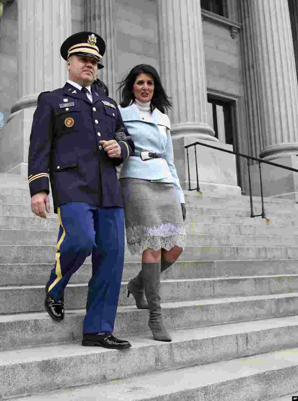South Carolina Gov. Nikki Haley, seen in this Jan. 14, 2015 file photo, is escorted down the steps of the Capitol by her husband Michael, in Columbia, S.C. President-elect Donald Trump has chosen Haley as U.S. ambassador to the United Nations, the first w