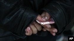 A man waits to contribute money at Beijing home of dissident artist Ai Weiwei, Nov. 7, 2011.