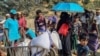 Rohingya refugees gather to collect relief materials from a distribution point in the Kutupalong Refugee Camp in Ukhia in Bangladesh's Cox's Bazar district on March 6, 2025.