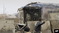 Afghans throw stones towards US soldiers in front of the US base in Bagram, during an anti US demonstration, February 21, 2012.