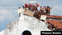 Inmates protest on the top of a prison building, in Colombo, Nov. 18, 2020.