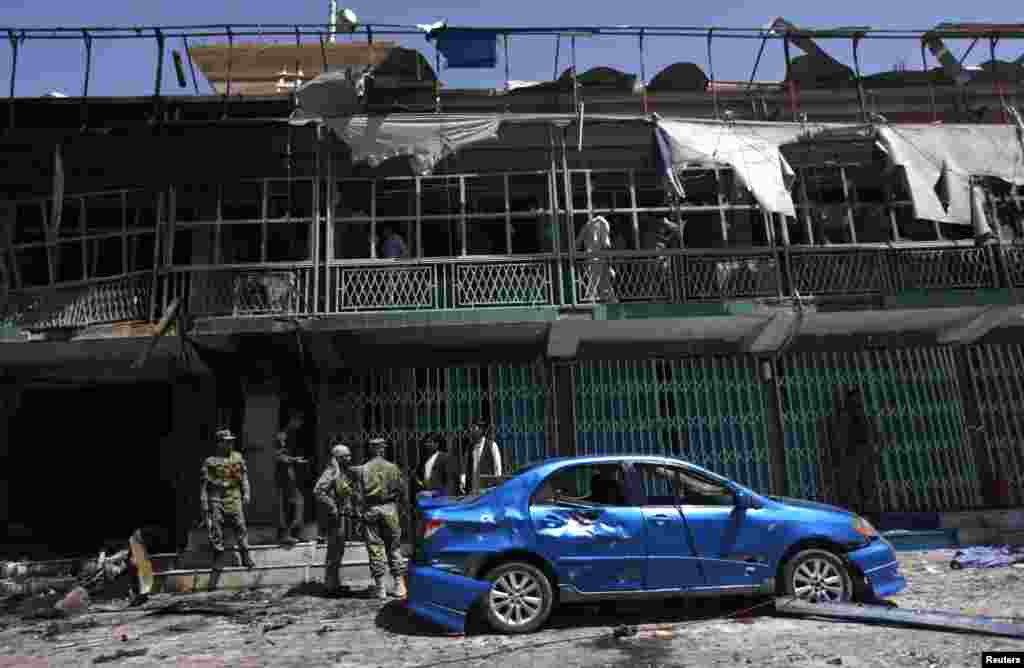 Afghan police guard at the site of a suicide attack in Kabul, May 16, 2013.