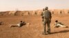 FILE - Members of the Maghawir al-Thawra Syrian opposition group receive firearms training from U.S. Army Special Forces soldiers at the Al-Tanf military outpost in southern Syria on Oct. 22, 2018.