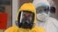 FILE - Russian President Vladimir Putin wears a protective suit as he visits a hospital for coronavirus patients in Kommunarka, outside Moscow, March 24, 2020.
