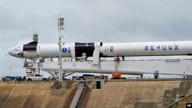 The SpaceX Falcon 9, with Dragon crew capsule is serviced on Launch Pad 39-A, Tuesday, May 26, 2020, at the Kennedy Space Center in Cape Canaveral, Fla. Two astronauts will fly on the SpaceX Demo-2 mission to the International Space Station.