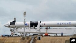 The SpaceX Falcon 9, with Dragon crew capsule is serviced on Launch Pad 39-A, Tuesday, May 26, 2020, at the Kennedy Space Center in Cape Canaveral, Fla. Two astronauts will fly on the SpaceX Demo-2 mission to the International Space Station…