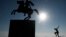 A skateboarder practices next to the modern bronze statue of Alexander the Great on his horse Bucephalus in the northern port city of Thessaloniki, Greece, Jan. 30, 2018. Parts of the city have been without water for five days because of a failed water pipe.