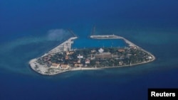 FILE - An aerial view shows Southwest Cay, also known as Pugad Island, controlled by Vietnam and part of the Spratly Islands in the disputed South China Sea, April 21, 2017.