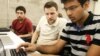 Shiva Gopalan, an international and computer engineering master's student at Texas A&M University (far right), confers with IBM developers Henrique Copelli Zambon (center) and Luiz Aoqui, during an IBM hosted Spark Hackathon at Galvanize, a tech hub in San Francisco on Sunday, June 14, 2015. (George Nikitin/Feature Photo Service for IBM)