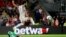 Crystal Palace's goalkeeper Wayne Hennessey, left, makes a save in front of Liverpool's Mohamed Salah during the English Premier League soccer match between Crystal Palace and Liverpool at Selhurst Park stadium in London, Monday, Aug. 20, 2018. 