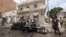 FILE - A Somali soldier stands on guard next to a destroyed car near a popular mall after a car bomb attack in Mogadishu, Somalia, July 30, 2017. The Somalia-based extremist group al-Shabab often carries out deadly bombings in Mogadishu. 