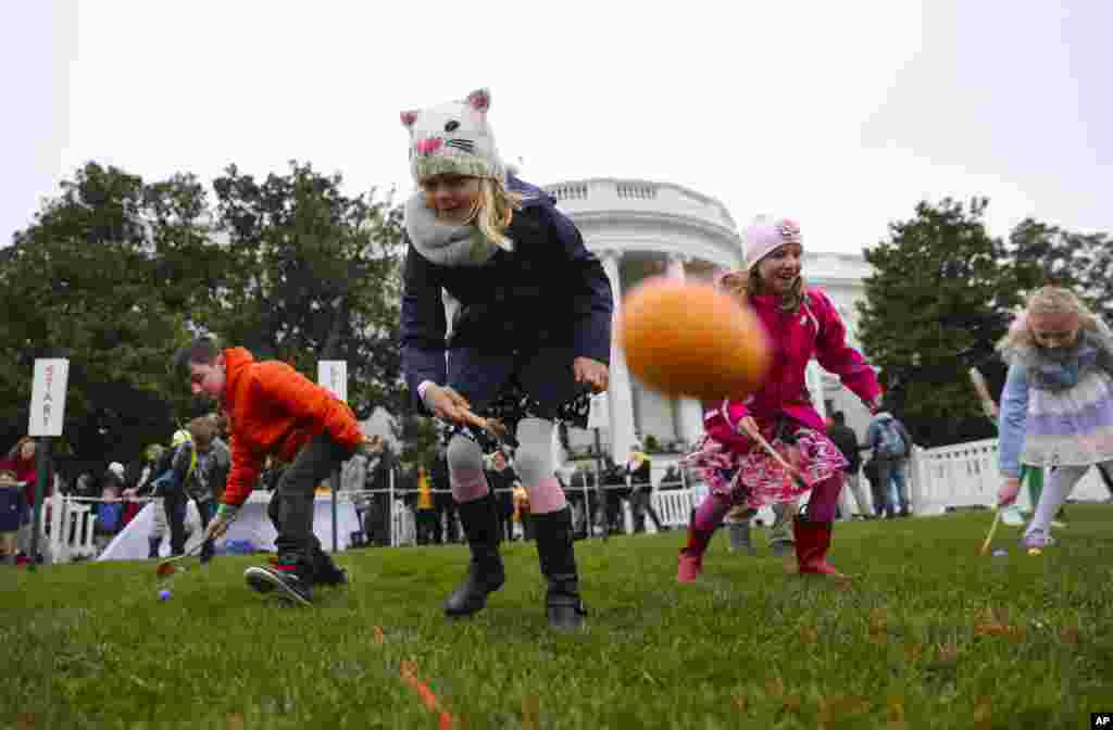 Julia Stimson, 8, from Alexandria, Va., and other children participate in the annual Easter Egg Roll on the South Lawn of the White House in Washington, April 2, 2018.