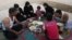 Syrian refugee family members break their fasting outside their tent at a refugee camp in the eastern town of Marj in Bekaa valley, Lebanon, June 29, 2014. 