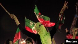 A supporter of the chairman of the Pakistan Tehreek-e-Insaf political party Imran Khan, a former international cricketer, cheers while listening to him speak during what has been dubbed a "freedom march" in Islamabad, August 28, 2014.