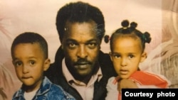 FILE - Dawit Isaak, an Eritrean-Swedish journalist and advocate for human rights, center, poses with his children, who include his daughter, Betlehem Isaak, right, who continues to fight for the release of her father, who has been imprisoned without trial in Eritrea since 2001.