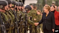 German chancellor Angela Merkel shakes hands with soldiers during a visit of the German Army medical service in Leer, northern Germany, Monday, Dec. 7, 2015. Germany's parliament voted last week to send military support in the fight against Islamic…