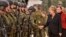 German chancellor Angela Merkel shakes hands with soldiers during a visit of the German Army medical service in Leer, northern Germany, Monday, Dec. 7, 2015. Germany's parliament voted last week to send military support in the fight against Islamic…