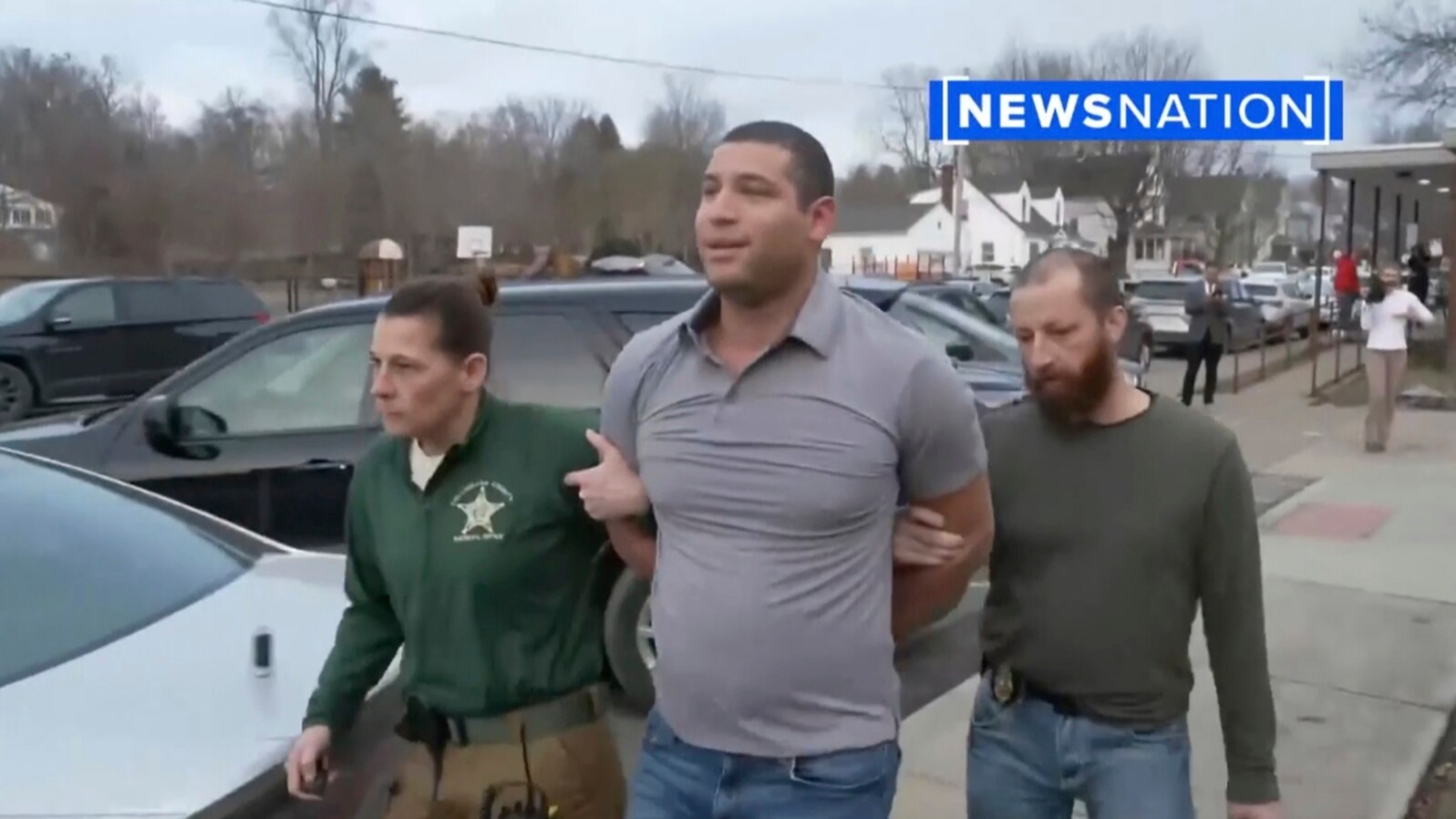 This image taken from video provided by Newsnation/TMX shows reporter Evan Lambert being taken into police custody on Wednesday, Feb. 8, 2023 in East Palestine, Ohio. (NewsNation TMX via AP)