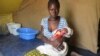 FILE - A woman holds her baby in Nangungue, eastern Cameroon, April 12, 2013. 