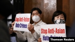 Members of the Atlanta Korean American Committee against Asian Hate Crime show placards as they meet at Ching Dam, a Korean restaurant, after the fatal shooting at three Georgia spas, in Duluth, Georgia, March 18, 2021.