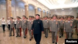 North Korean leader Kim Jong Un (C) visits the Kumsusan Palace of the Sun at midnight on Tuesday on the occasion of the 20th anniversary of the demise of President Kim Il Sung in this photo released by North Korea's Korean Central News Agency (KCNA) July 8, 2014.