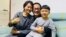 This handout photo taken on April 27, 2020 and released by Wang Qiaoling, shows human rights lawyer Wang Quanzhang (C) embracing his wife Li Wenzu and their son after they were reunited in Beijing, China.
