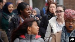 FILE - Brooklyn College students walk across campus for class, in Brooklyn, New York, Feb. 1, 2017.