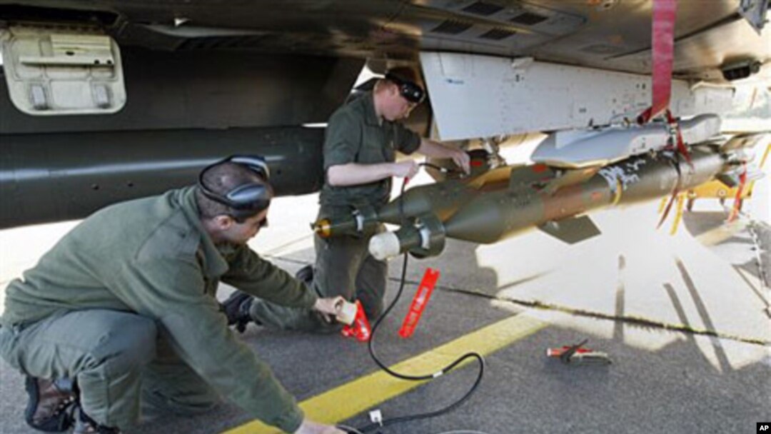 French military ground crew prepare a Mirage 2000 jet fighter for a mission to Libya, at Solenzara 126 Air Base, Corsica, Mar 23 2011