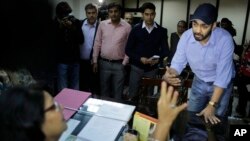 FILE - Uber’s General Manager for Delhi region Gagan Bhatia speaks to the Chairperson of Delhi Commission for Women Barkha Singh after being summoned by the commission in New Delhi, India, Dec. 9, 2014.