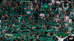 FILE - Saudi Arabia fans support their team during the Asian Cup Round of 16 soccer match between Saudi Arabia and South Korea in Al Rayyan, Qatar, Jan. 30, 2024. Saudi Arabia will host the 2034 World Cup.