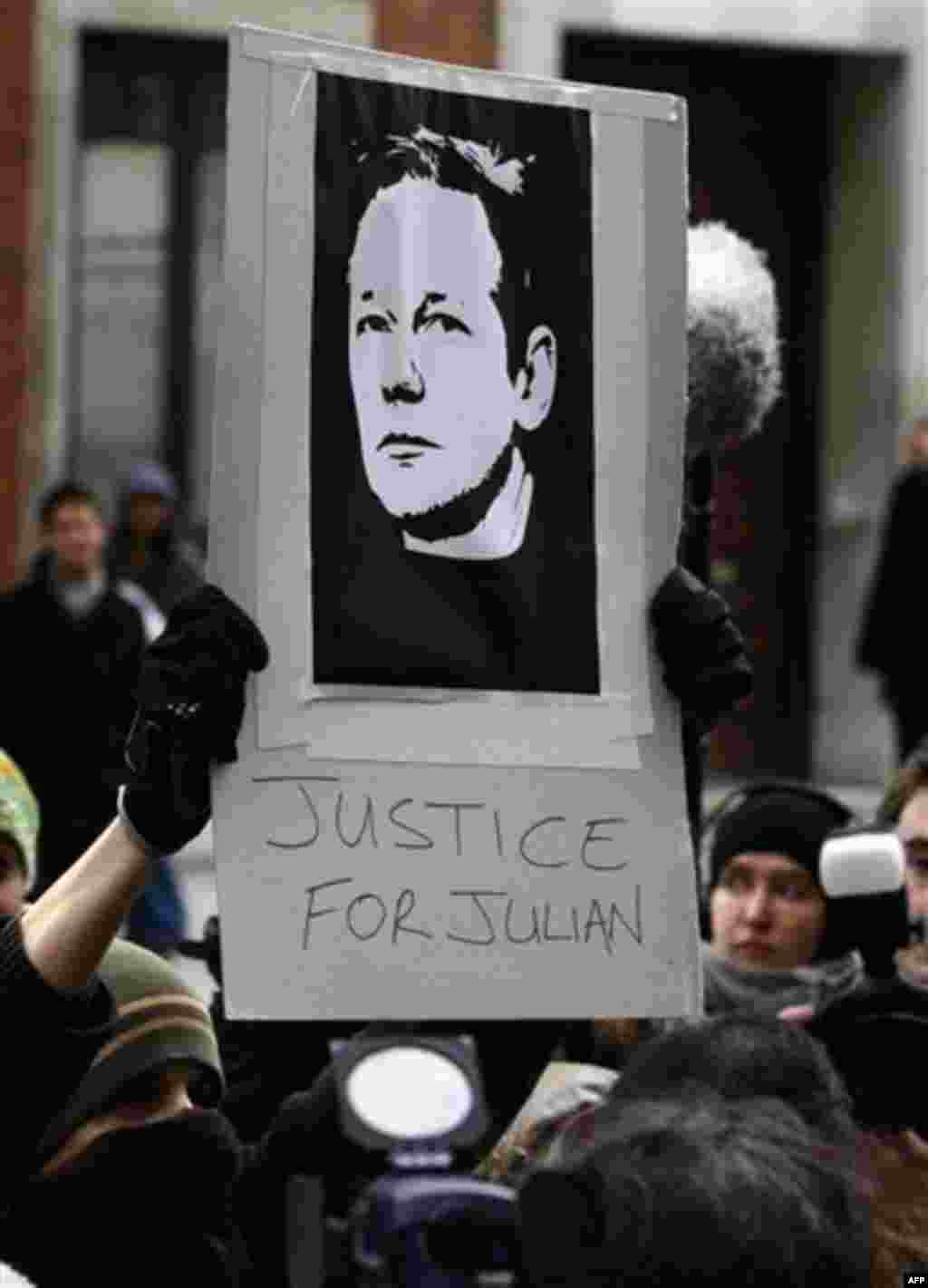 Members of the media gather around a demonstrator near Westminster Magistrates Court in London, Tuesday, Dec. 7, 2010, where WikiLeaks founder Julian Assange was denied bail after appearing on an extradition warrant. Assange surrendered to London police a