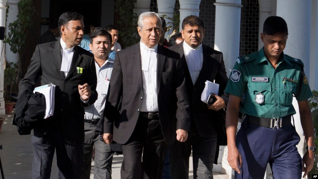FILE - Attorney General of Bangladesh, Mahbubey Alam, center, walks out of the Supreme Court after the hearing of a review petition relating to the death sentence of Harkatul Jihad leader, Mufti Abdul Hannan, in Dhaka, Bangladesh, Wednesday, Dec. 7, 2016. The court upheld the death sentence against Hannan and two of his accomplices found guilty of orchestrating a 2004 grenade attack against Bangladesh-born British High Commissioner, Anwar Choudhury, as he visited a popular Islamic shrine in the north-eastern city of Sylhet.