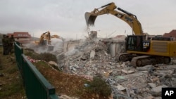 Bulldozers demolish houses in the West Bank settlement of Ofra, March 1, 2017. 