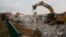 Bulldozers demolish houses in the West Bank settlement of Ofra, March 1, 2017. 