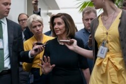 FILE - Speaker of the House Nancy Pelosi, D-Calif., is surrounded by reporters as she arrives to meet with her caucus at the Capitol in Washington, after declaring she will launch a formal impeachment inquiry against President Donald Trump.