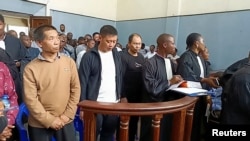 Chinese citizens arrested in possession of gold bars and $400,000 in cash and found guilty of illegal mining, stand inside the courtroom in Bukavu, South Kivu Province of the Democratic Republic of the Congo, Jan. 13, 2025. 