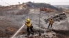 Firefighters extinguish hotspots as the Franklin Fire burns around Malibu, California, on Dec. 11, 2024. 