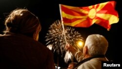 Supporters of the ruling Social Democratic Union of Macedonia wave a Macedonian flag during victory celebrations for the local elections in Skopje, Macedonia, Oct. 16, 2017.