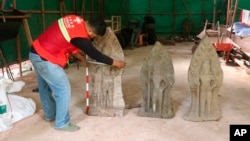 This photo provided by Apsara National Authority shows a centuries-old sandstone statue being measured at Angkor Thom in Cambodia on Oct. 24, 2024.