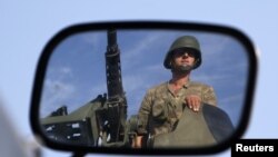 Flamingos stand in the flamingo pool, home to both the Caribbean and Chilean flamingos, at the Jurong Bird Park in Singapore.