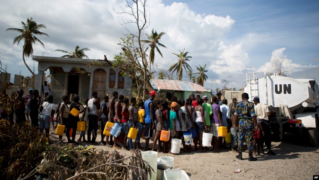 United Nations police from Bangladesh deliver drinking water to residents of Sous-Roche village, outside Les Cayes, Haiti, Oct. 11, 2016. 
