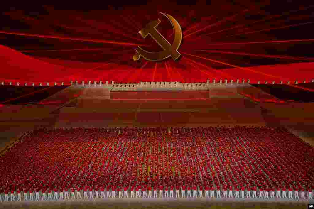 Performers line up in front of the Communist Party emblem at a gala show ahead of the 100th anniversary of the founding of the Chinese Communist Party in Beijing.
