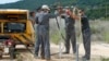 FILE - Workers conduct an onshore gas and oil inspection in Batroun, northern Lebanon, October 2013.