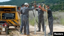 FILE - Workers conduct an onshore gas and oil inspection in Batroun, northern Lebanon, October 2013.