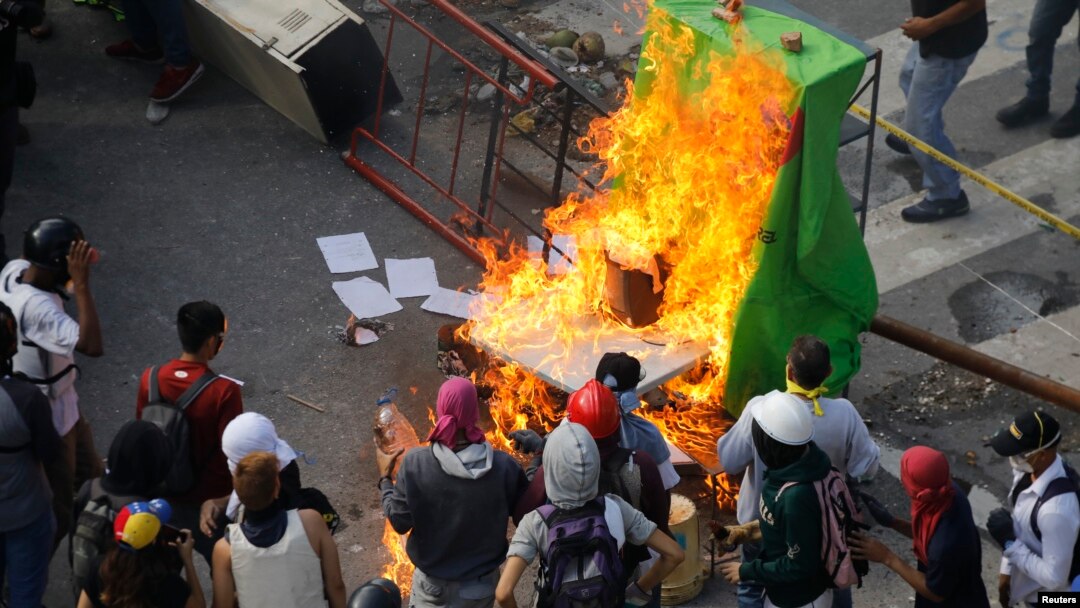 Demonstrators watch a barricade burn after clashes broke out while the Constituent Assembly election is being carried out in Caracas, Venezuela, July 30, 2017.