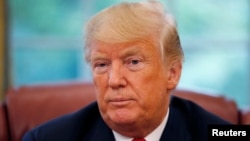 U.S. President Donald Trump listens to a question during an interview with Reuters in the Oval Office of the White House in Washington, Aug. 20, 2018. 